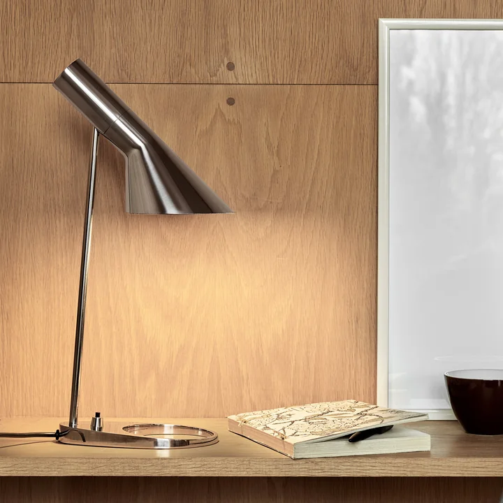 The AJ table lamp from Louis Poulsen on a wooden desk