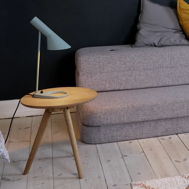The AJ table lamp from Louis Poulsen on a side table in the living room