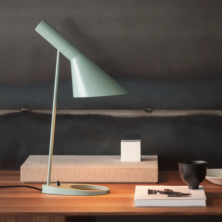 The AJ table lamp from Louis Poulsen on a desk