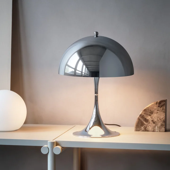 The Panthella, high-gloss chrome-plated from Louis Poulsen as a decorative light on the sideboard