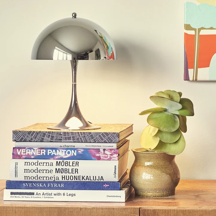 The Panthella high-gloss chrome-plated from Louis Poulsen as a decorative object on coffee table books