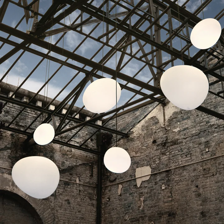The Gregg Outdoor pendant lights, white by Foscarini in an industrial hall