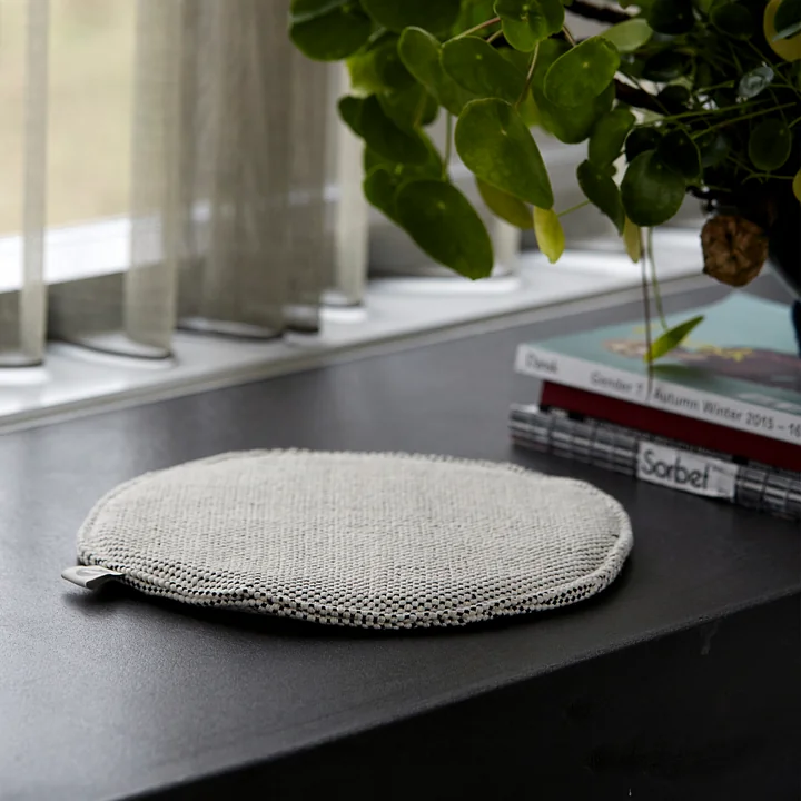 The seat cushion for Cuun rattan chair Ø 35 cm, black / white by House Doctor on a windowsill