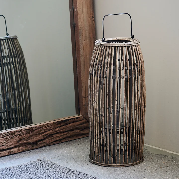 The Ova lantern, H 65 cm, natural by House Doctor next to a mirror