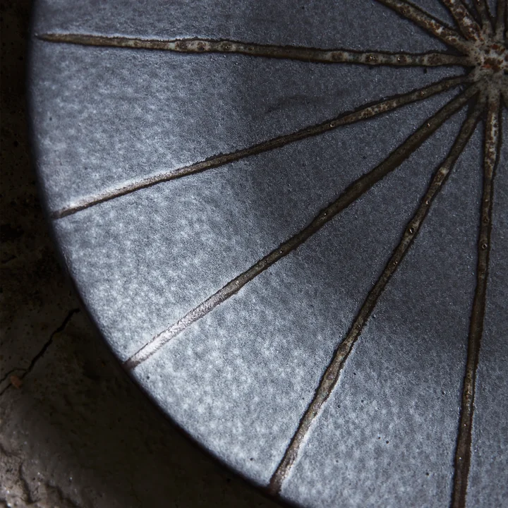 The Suns plate, Ø 15.7 cm, dark brown by House Doctor is characterized by its sunshine look