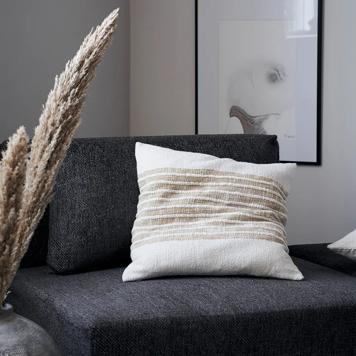 The Yarn pillowcase, light brown by House Doctor on an armchair in the living room