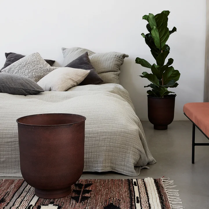 The Vig plant pots, burnt henna (set of 2) from House Doctor next to the bed in the bedroom