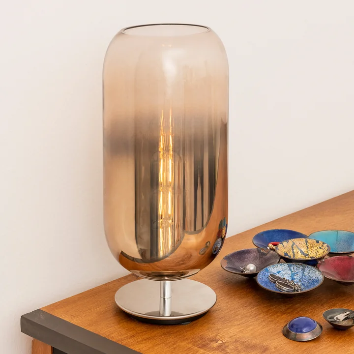 The Gople table lamp H 48.5 cm, bronze by Artemide, set in scene with matching decoration