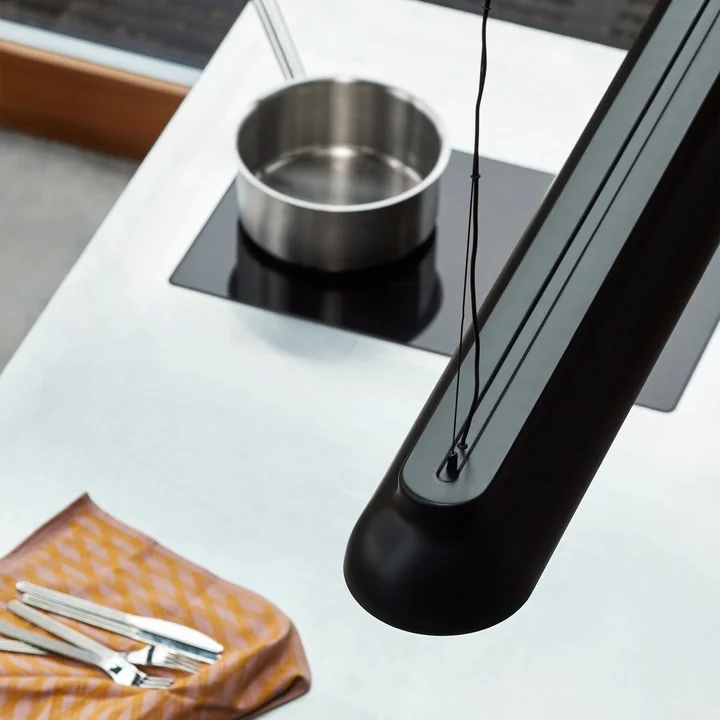 The PC Linear rod pendant light, soft black from HAY above the kitchen island