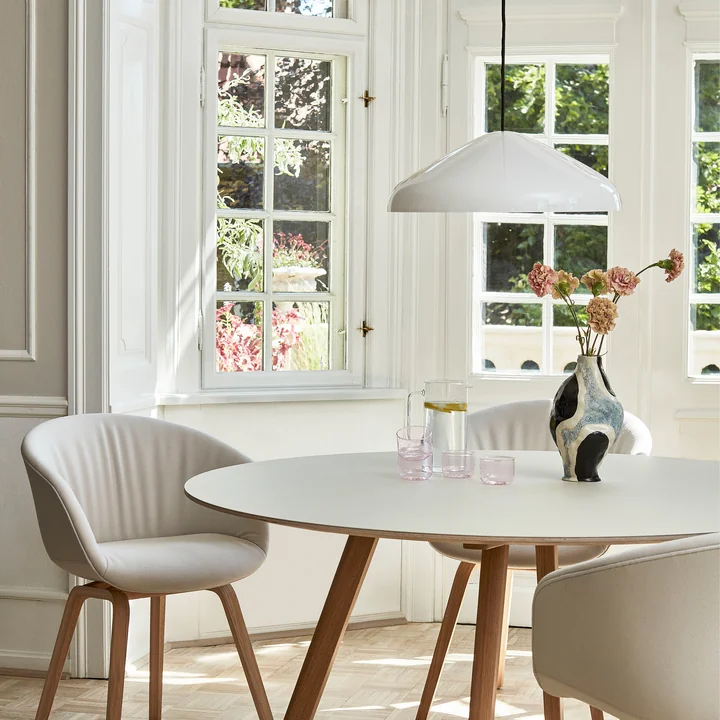 The Pao Steel pendant lamp, Ø 47 x H 16.25 cm, cream by HAY above a small dining table in a bright room
