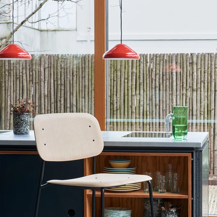 The Pao Steel pendant lamp, Ø 23 x H 10 cm, red by HAY over a kitchen island