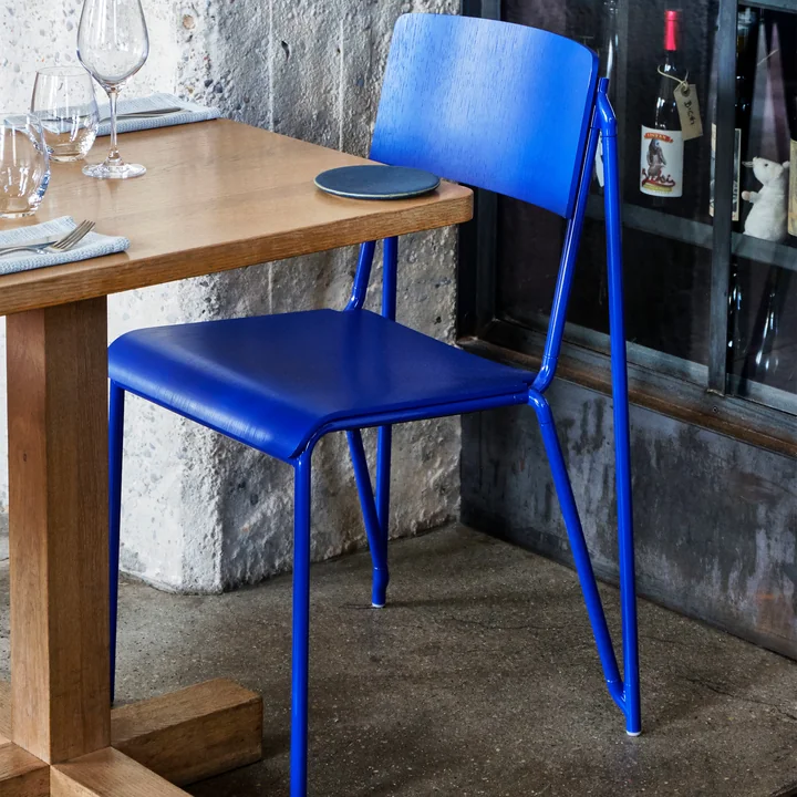 The Petit Standard chair, ultra marine blue / ultra marine blue by HAY on a wooden table in the wine cellar