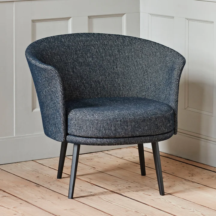 The Dorso armchair, powder-coated steel, fairway dark blue (308-288) by HAY in the living room with a lot of wood