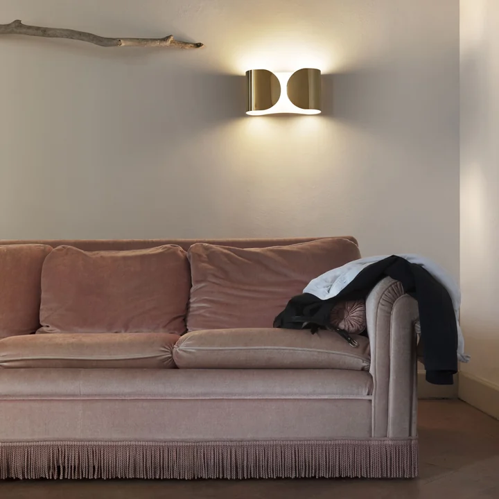The Foglio wall lamp by Flos in the living room above the sofa