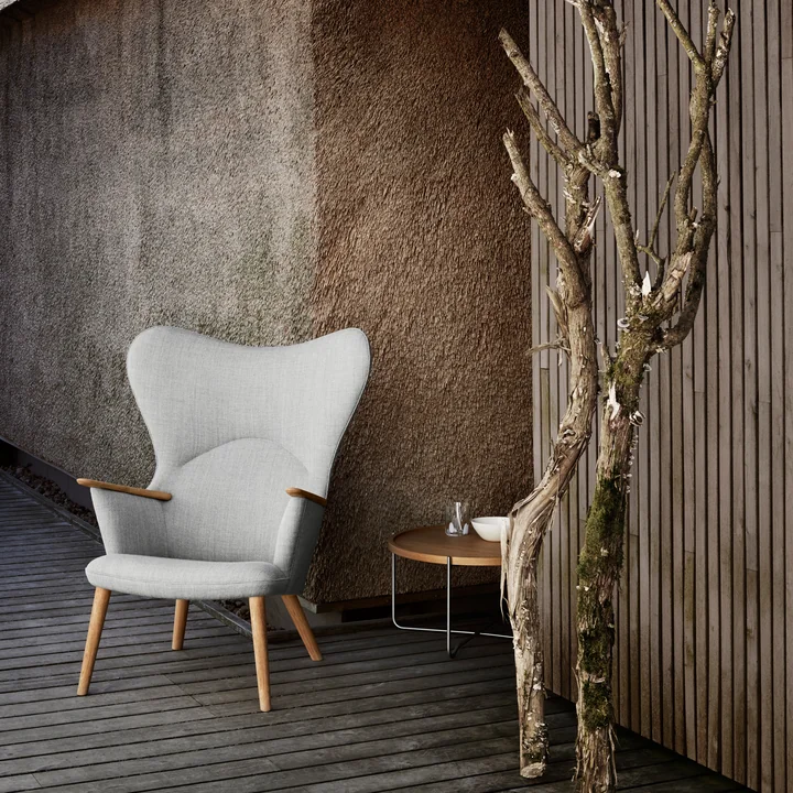 The CH78 Mama Bear Lounge Chair of Carl Hansen outdoor on a wooden terrace