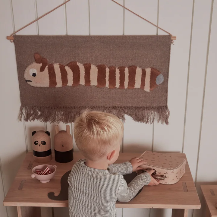 The Leo Larva tapestry and the Tiny Inka silicone bowl on the Arca children's table by OYOY