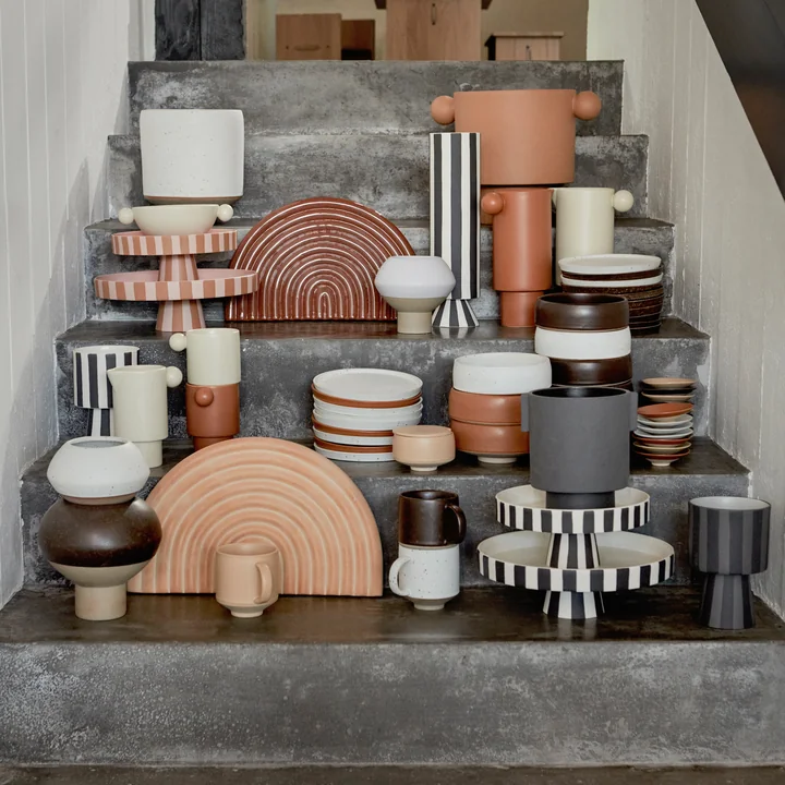 The Toppu tray with other crockery from OYOY on a stone staircase