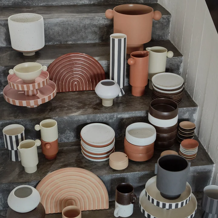 The Toppu tray with other crockery from OYOY on a staircase