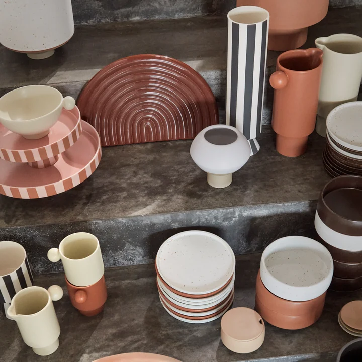 The Toppu tray with other crockery from OYOY on a staircase