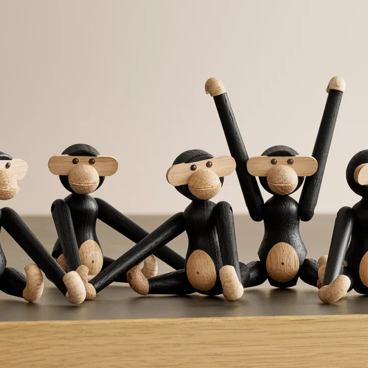 The mini wooden monkey, stained black oak by Kay Bojesen in a group with other wooden monkeys