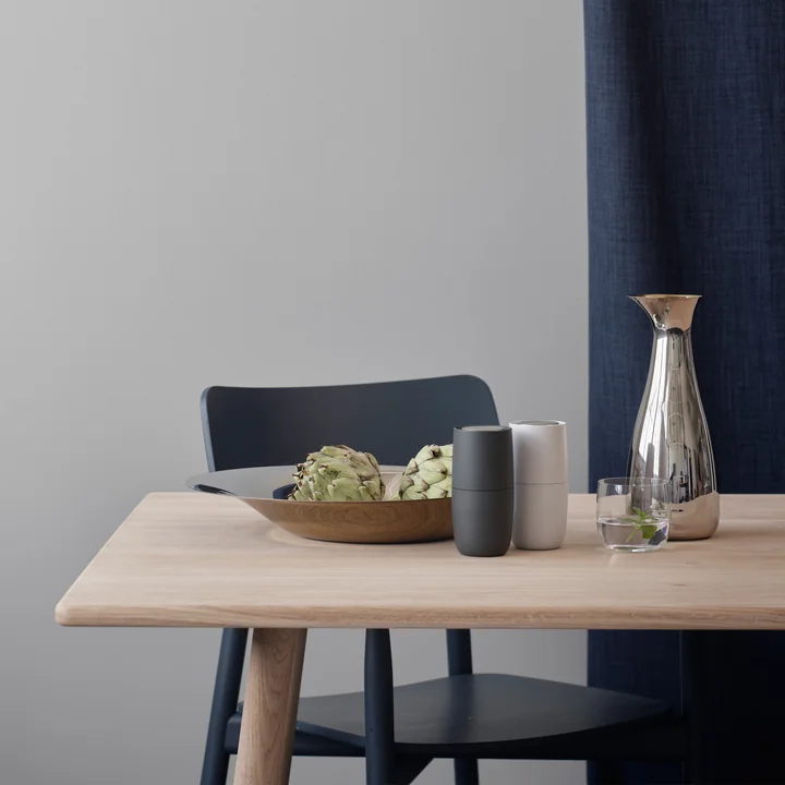 The Foster salt and pepper mill from Stelton on the laid dining table