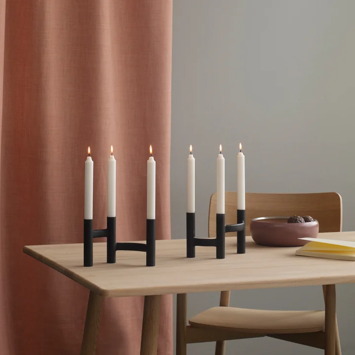 The three-armed candle holder from Stelton in combination on the table