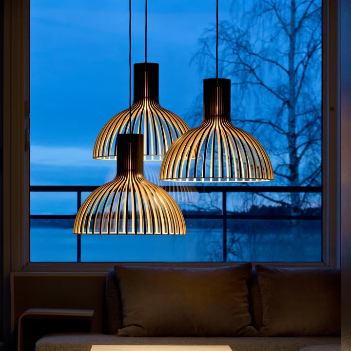 The Victo Small 4251 pendant light from Secto above the coffee table in front of a large panorama window