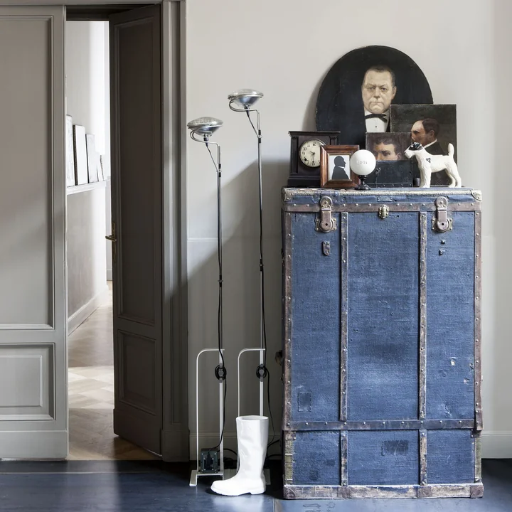 The Toio ceiling spotlight by Flos next to a chest of drawers in the hall