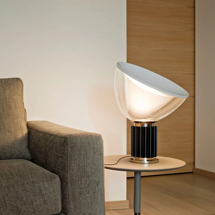 The Taccia small LED table lamp from Flos on a side table in the living room