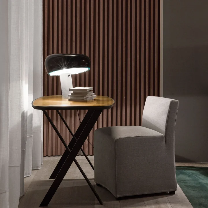 The Snoopy Table lamp from Flos in a reading corner on a side table
