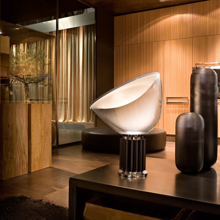 The Taccia LED table lamp from Flos in an elegant ambience with lots of wood