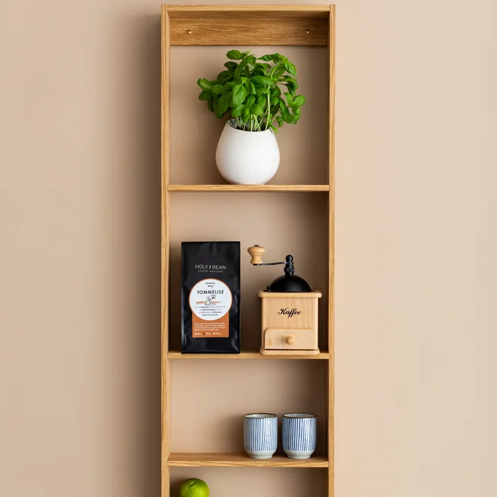 The Foursquare wall shelf from We Do Wood as a storage place for plants, a coffee grinder and cups
