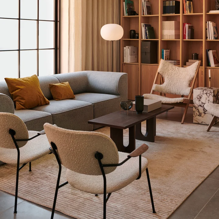 The Houkime rug, beige in combination with the Knitting Chair, natural oak, Sheepskin Moonlight 09 from Audo in the living area.