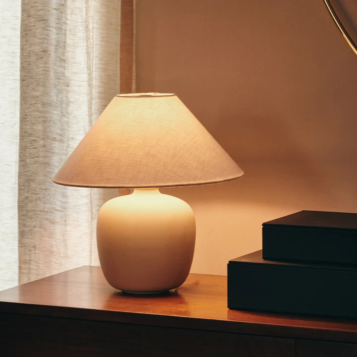 The Torso table lamp, sand / off white from Audo on a chest of drawers