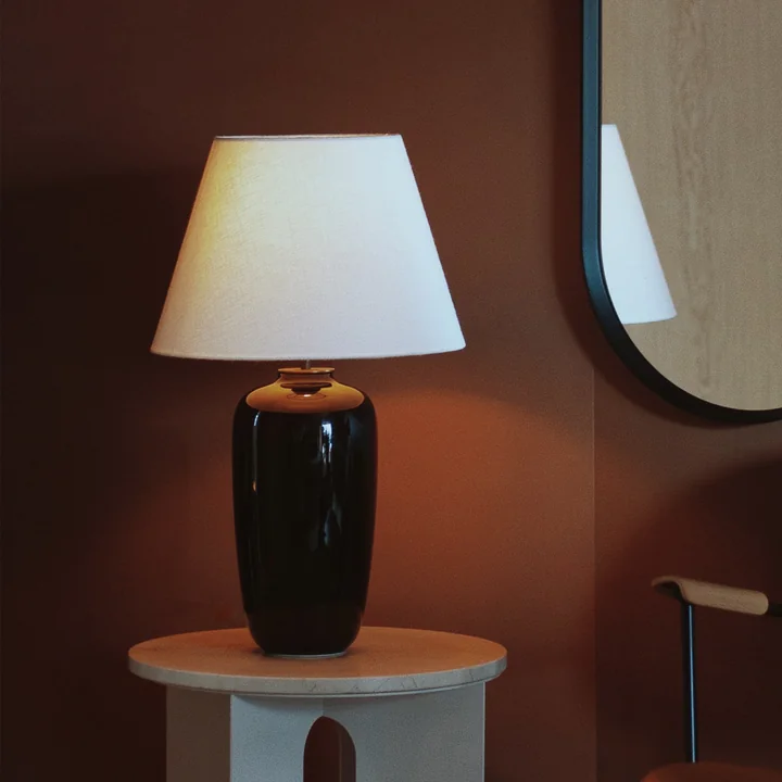 The Torso table lamp, black / off white from Audo on a side table
