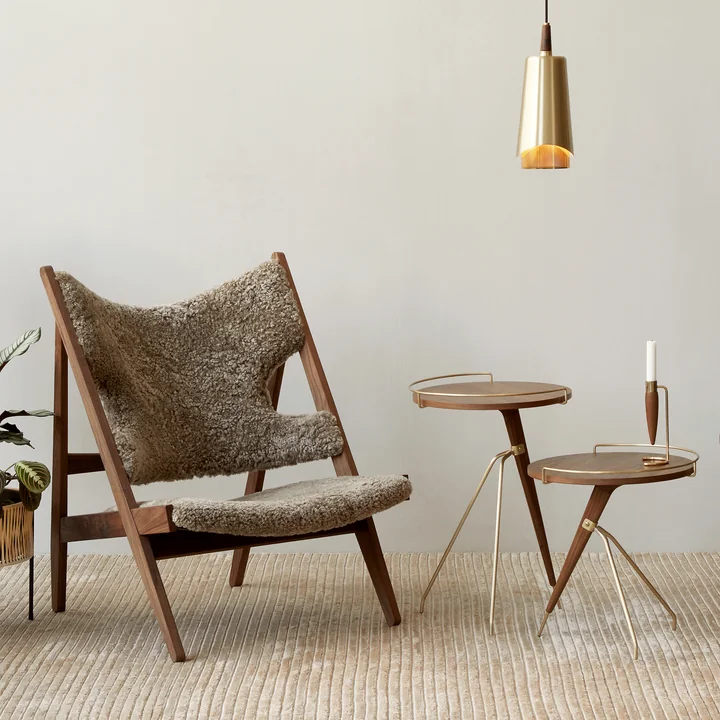 Lounge armchair with sheepskin and side tables in walnut