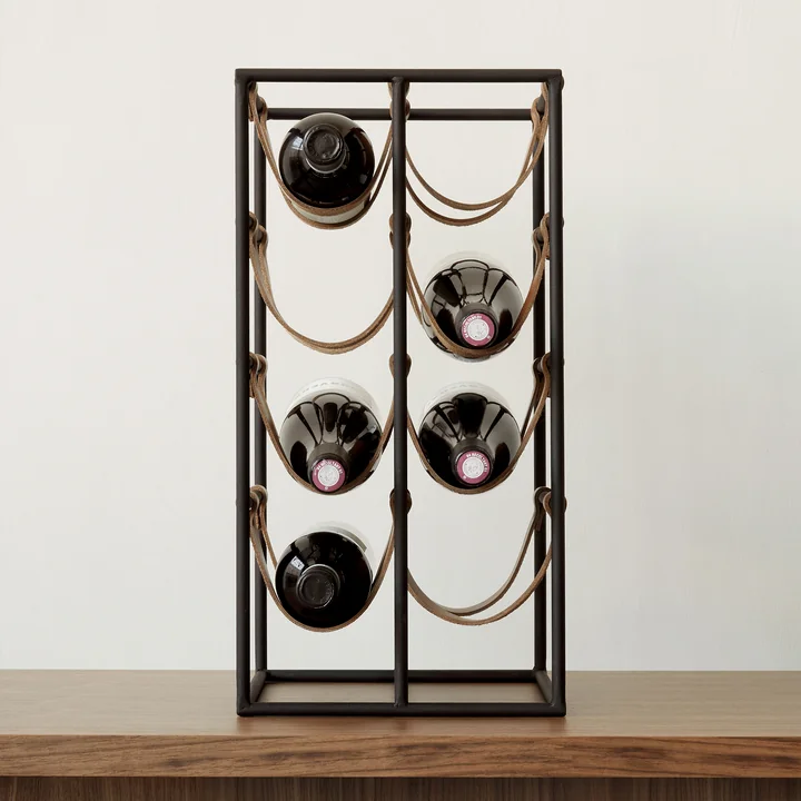 The Umanoff wine rack for 8 bottles, steel black (RAL 9005) / leather brown from Audo holds space for 8 wine bottles