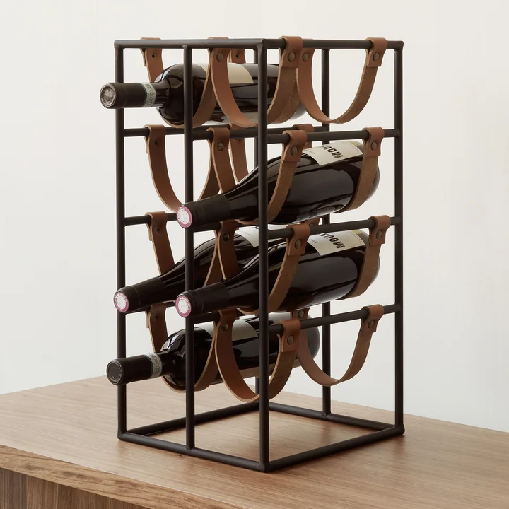 Umanoff wine rack for 8 bottles, steel black (RAL 9005) / leather brown from Audo was designed by Arthur Umanoff