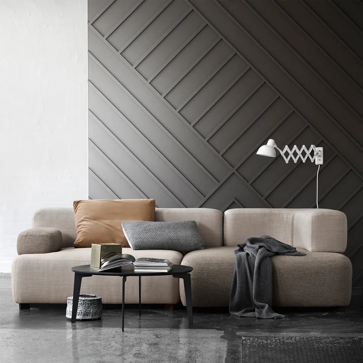 The modular Alphabet sofa from Fritz Hansen with blankets and cushions in natural colours and a black coffee table