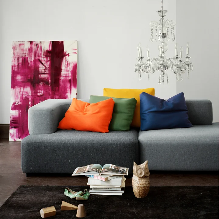 The modular Alphabet sofa of Fritz Hansen with colourful cushions and in combination with a noble chandelier