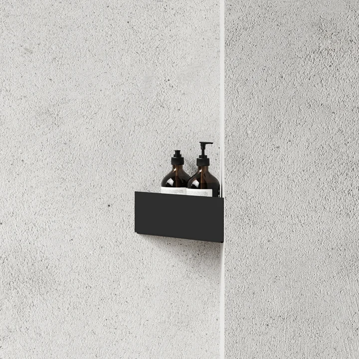 The wall shelf of Nichba Design in the corner of a stone wall