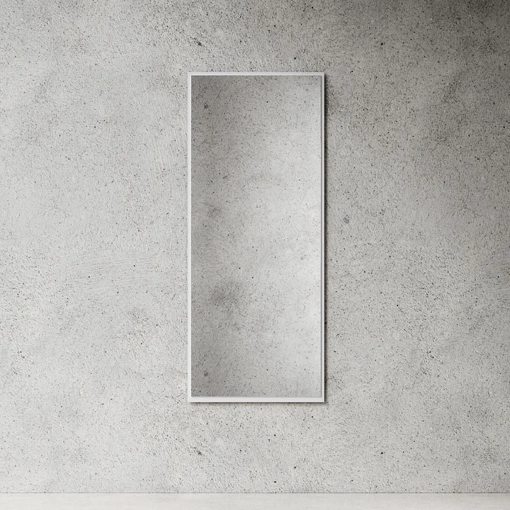 The large wall mirror from Nichba Design in white on a stone wall