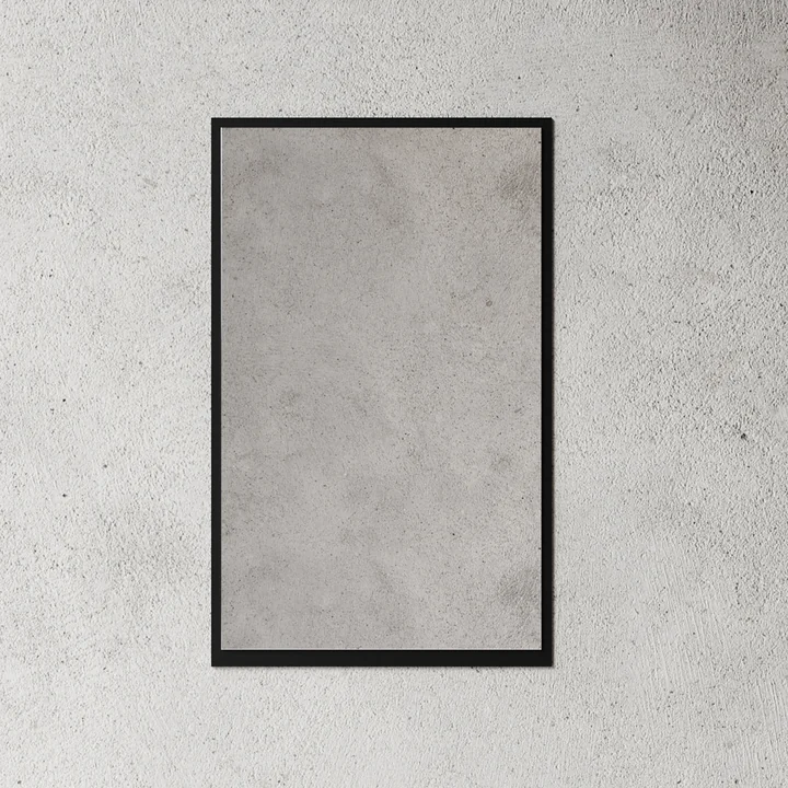 The small wall mirror from Nichba Design in black on a stone wall