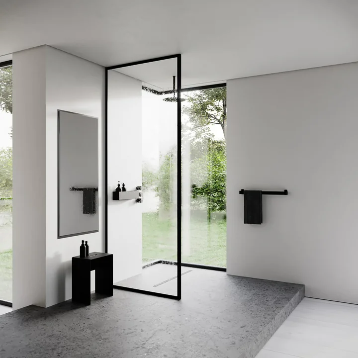 The stool from Nichba Design in the modern, minimalist bathroom as a shelf for shampoo and co.