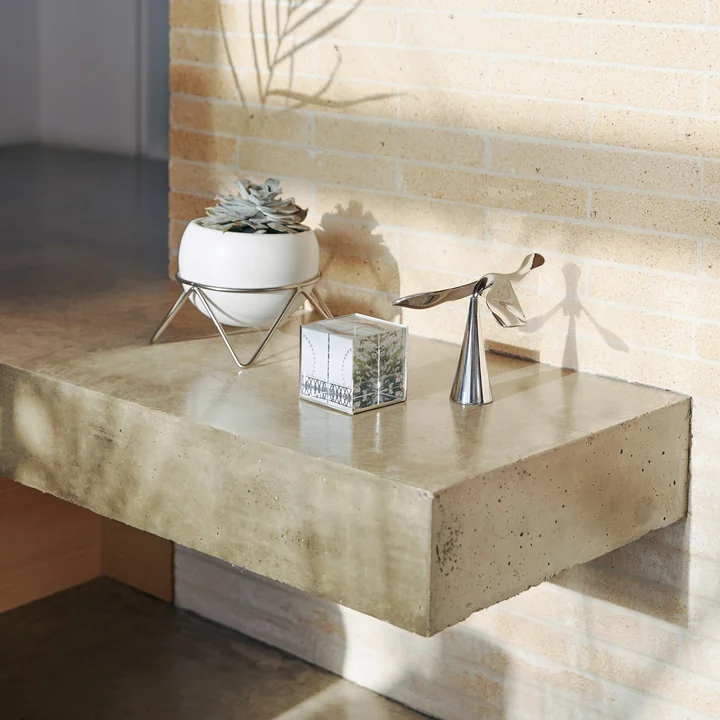 The Tipsy bottle opener from Umbra among other decorative objects on the stone floor