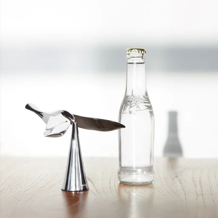 The Tipsy bottle opener from Umbra next to a glass water bottle