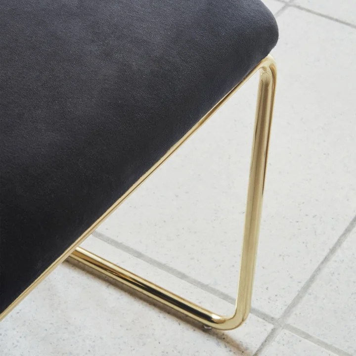 The Angui bench from AYTM with gold-plated frame and black seat