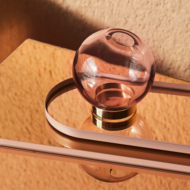 The Globe vase of AYTM in rose on a mirrored table