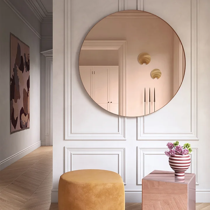 The Circum wall mirror with rose colored glass from AYTM in a bright old apartment