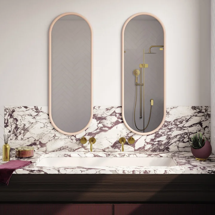 The Angui wall mirror from AYTM above the marble sink in the bathroom
